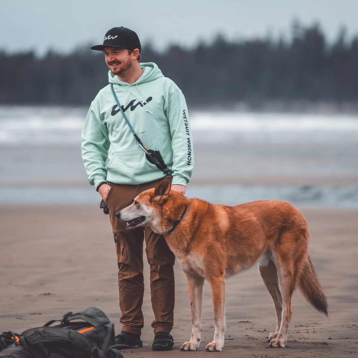Kyle Sawyer on the beach with his dog