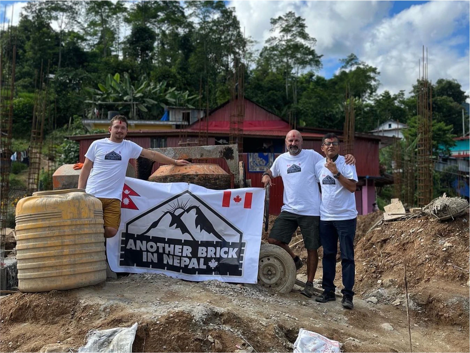 Another Brick in Nepal members holding sign