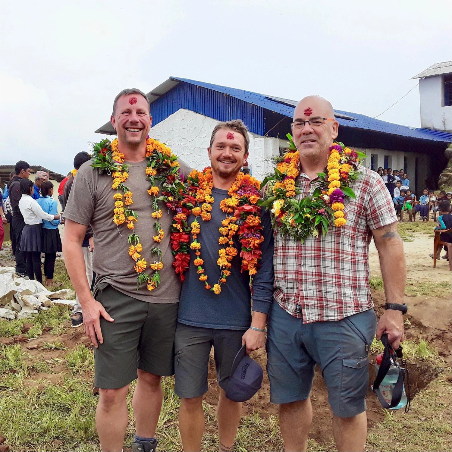 Kyle Sawyer standing with other members of Another Brick in Nepal