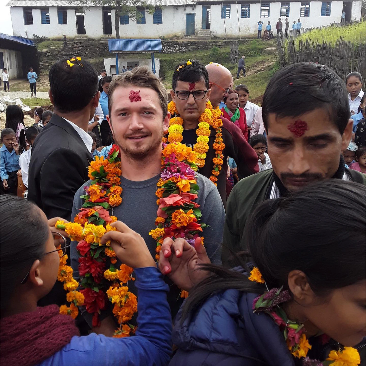 Kyle Sawyer standing in group of Nepalese people